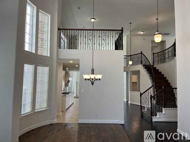 A large open space with a staircase and a chandelier.