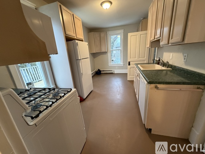 A kitchen with white appliances and cabinets.