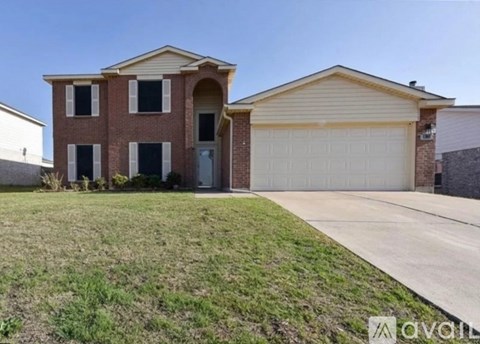 A two-story house with a garage is for sale.