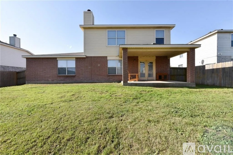 A house with a large front yard is for sale.