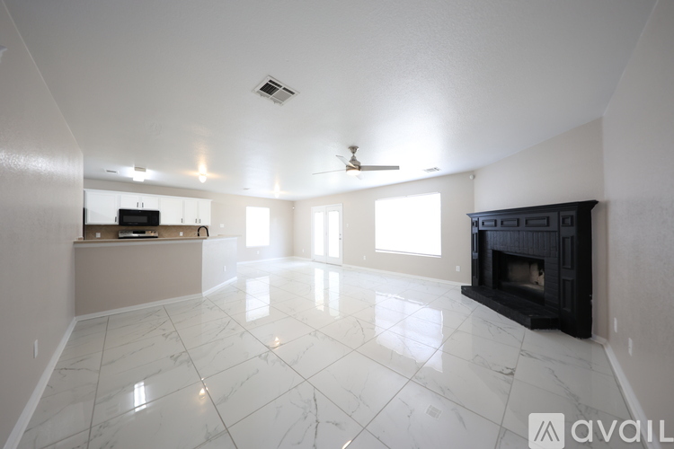A spacious living room with a fireplace and a television.