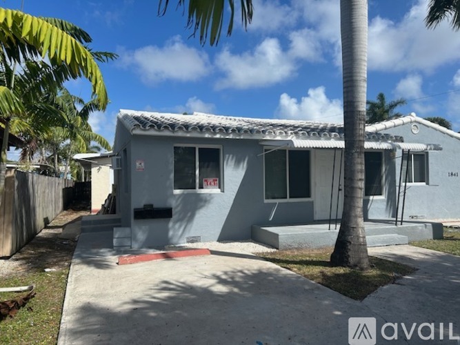 A house with a palm tree in front of it.