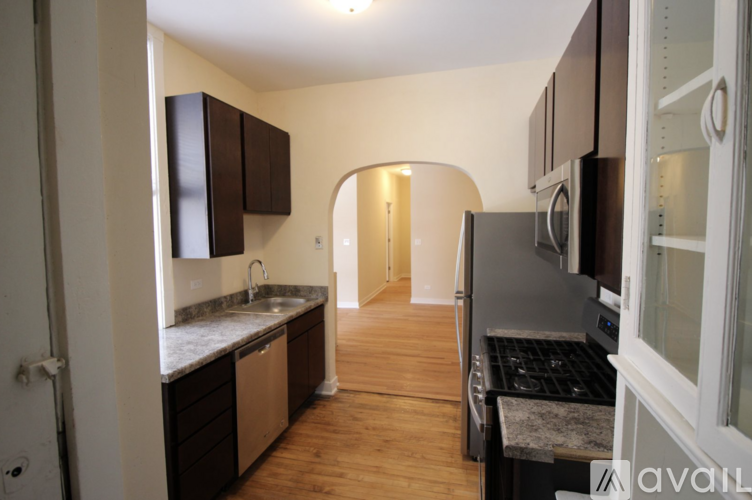 A kitchen with wooden floors and a sink.