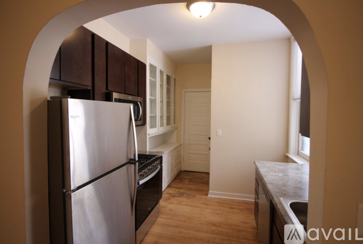 A kitchen with a refrigerator, stove, and sink.