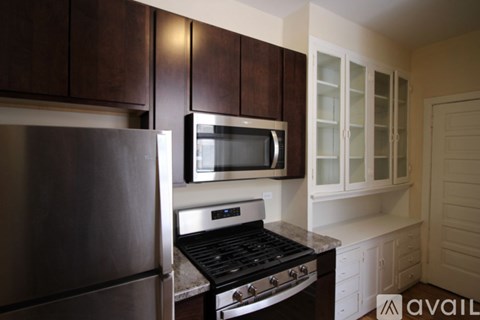 A kitchen with a stove top oven and microwave above it.