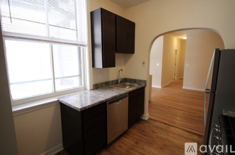 A kitchen with a sink and a window.