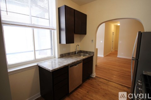 A kitchen with a sink and a window.