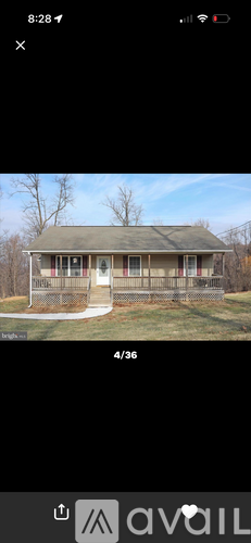 A house with a green roof and a porch with a railing.