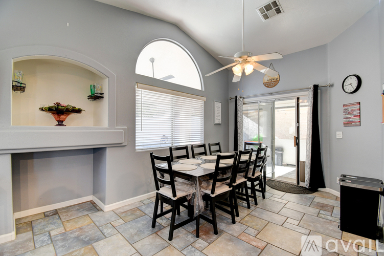 A dining room with a table set for six.
