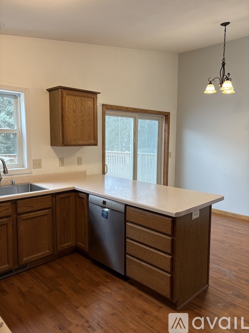 A kitchen with wooden cabinets and a dishwasher.