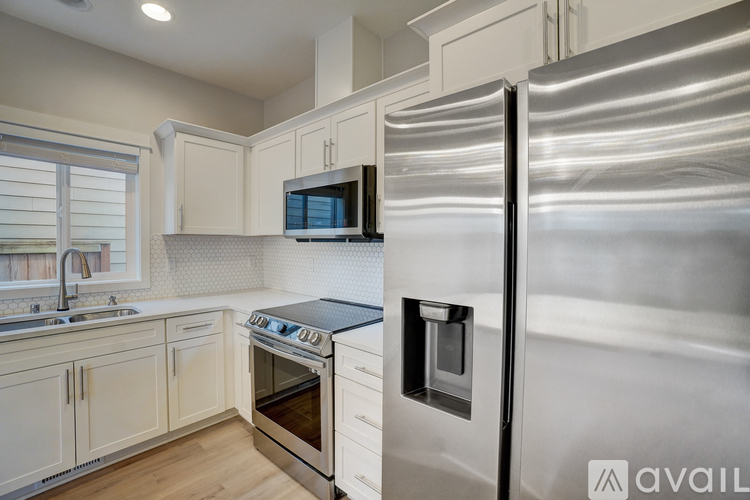 A modern kitchen with a stainless steel refrigerator.
