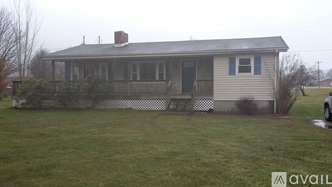 A house with a grey roof and a white fence.