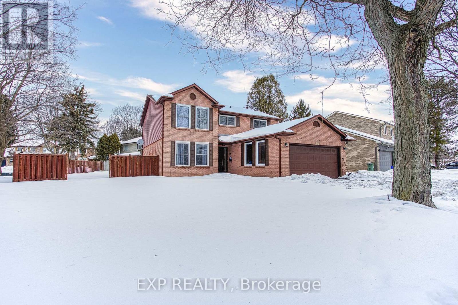 A house with a red brick exterior is surrounded by snow.