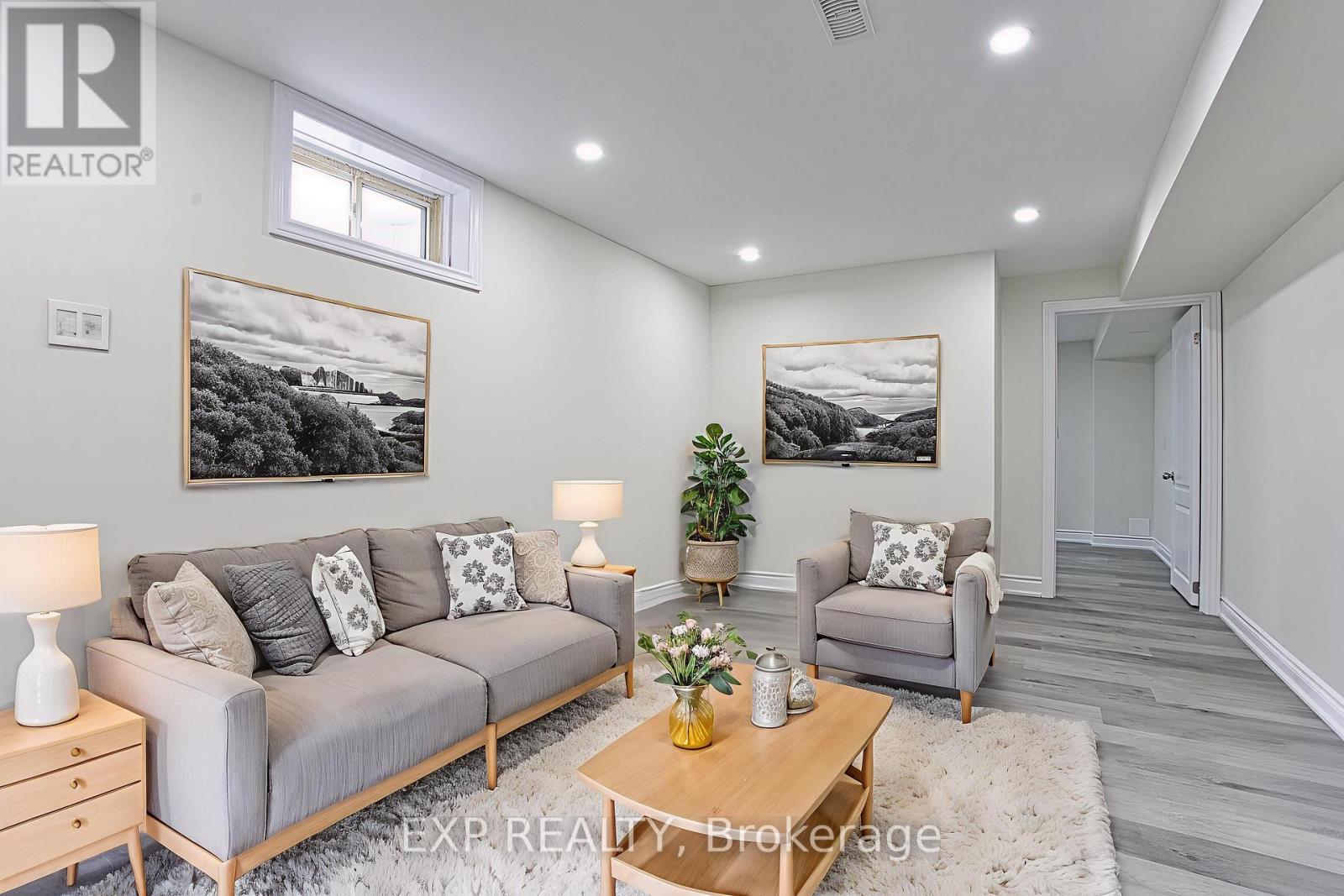 A living room with a grey couch, a coffee table, and two lamps.