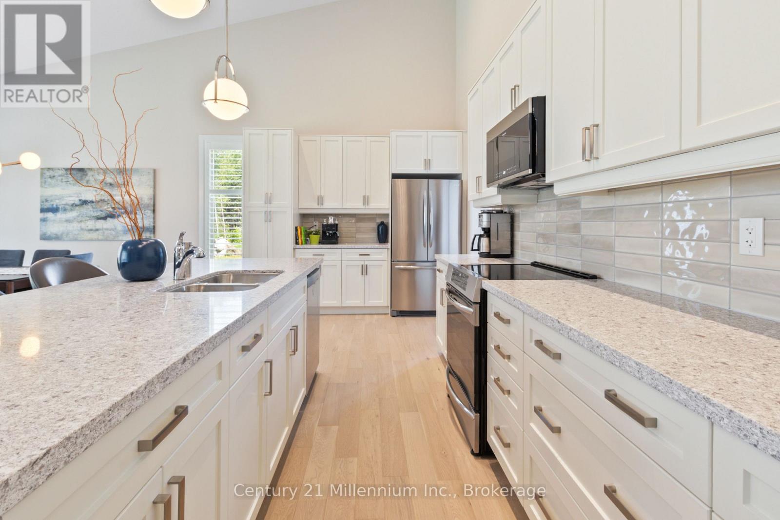 A kitchen with white cabinets and a granite countertop.