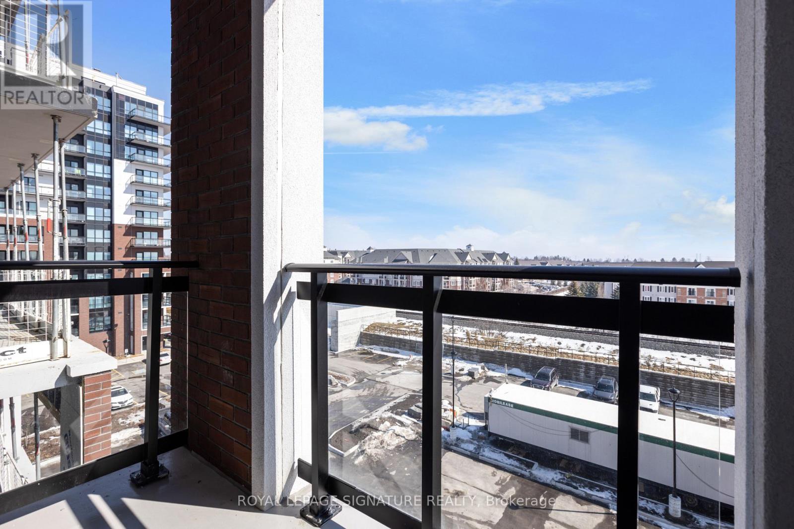A balcony with a view of a construction site and buildings.