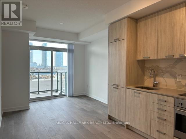 A kitchen with wooden cabinets and a stainless steel oven.