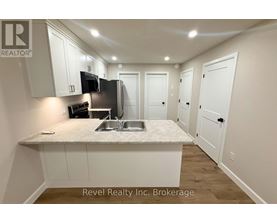 A kitchen area with a sink, microwave, and oven.