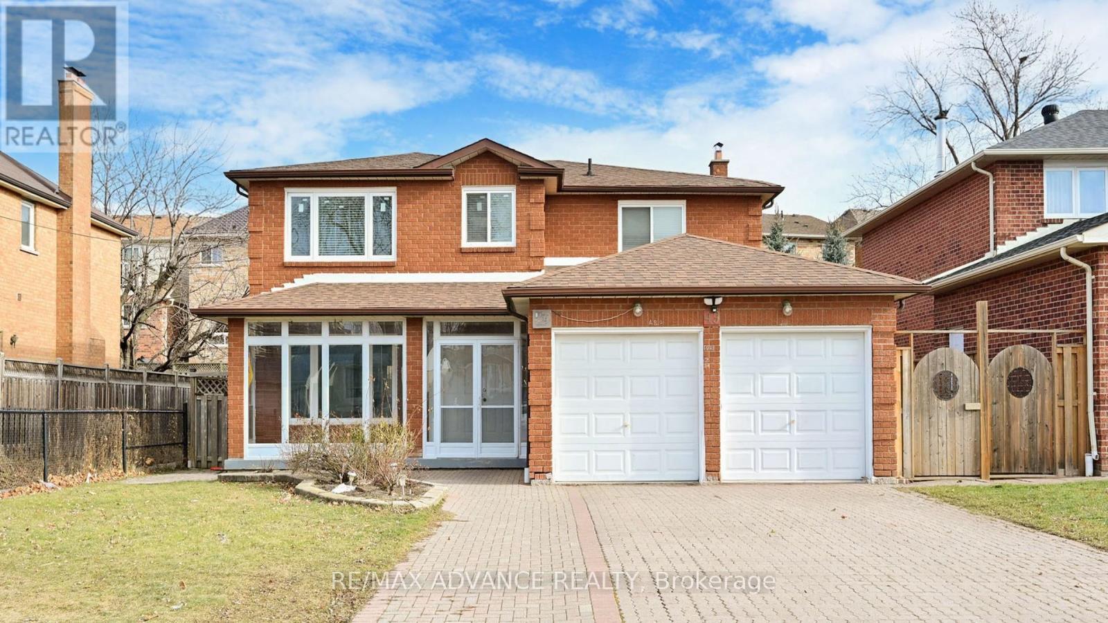 A house with a brick facade and a white garage door.