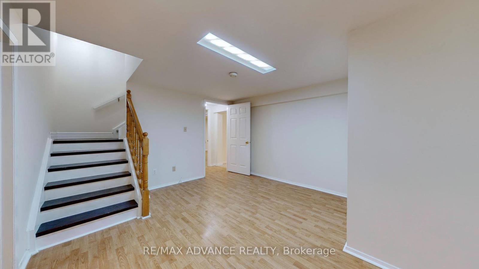 A room with a staircase and a door.
