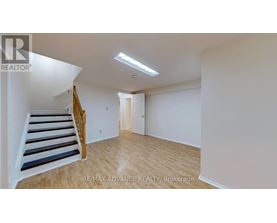 A room with a staircase and a door.