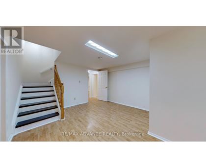 A room with a staircase and a door.