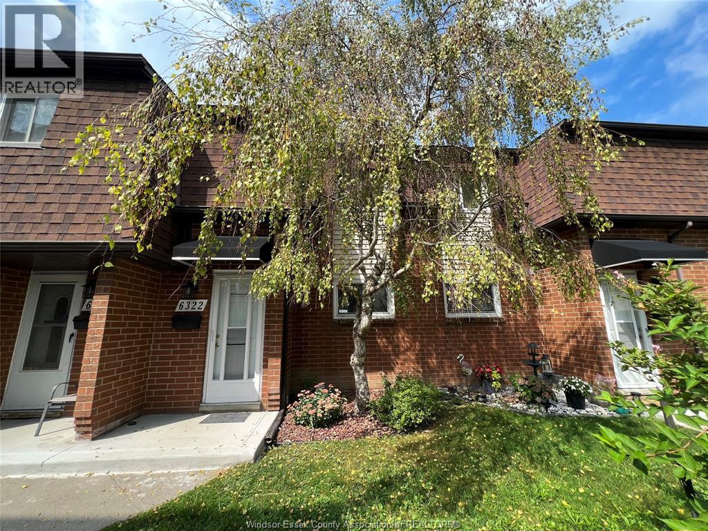 A house with a tree in front of it.