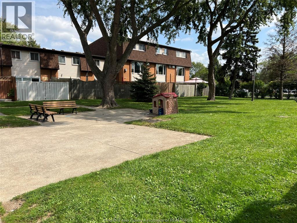 A park with a playground and a bench.