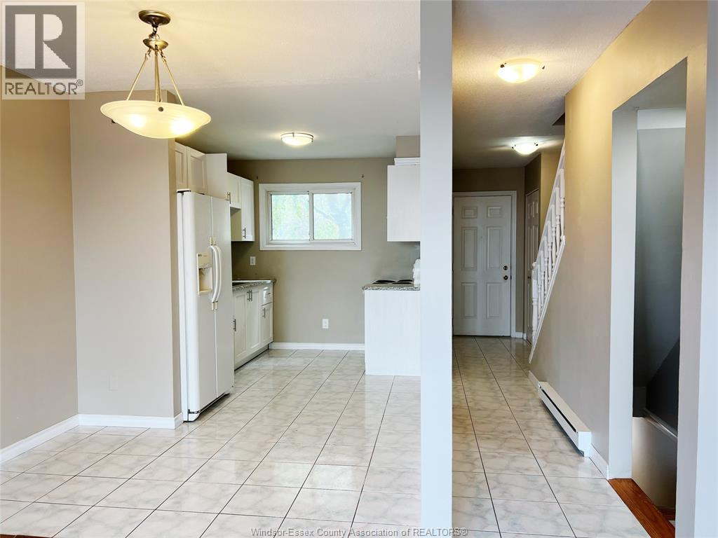 A kitchen with white appliances and a white fridge.