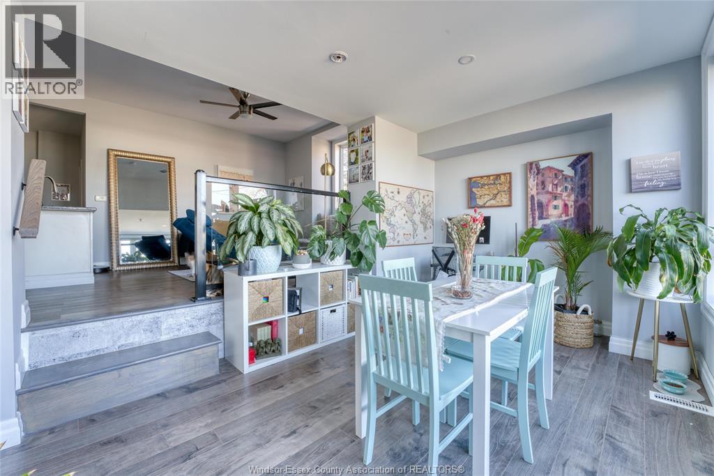 A dining room with a table and chairs.