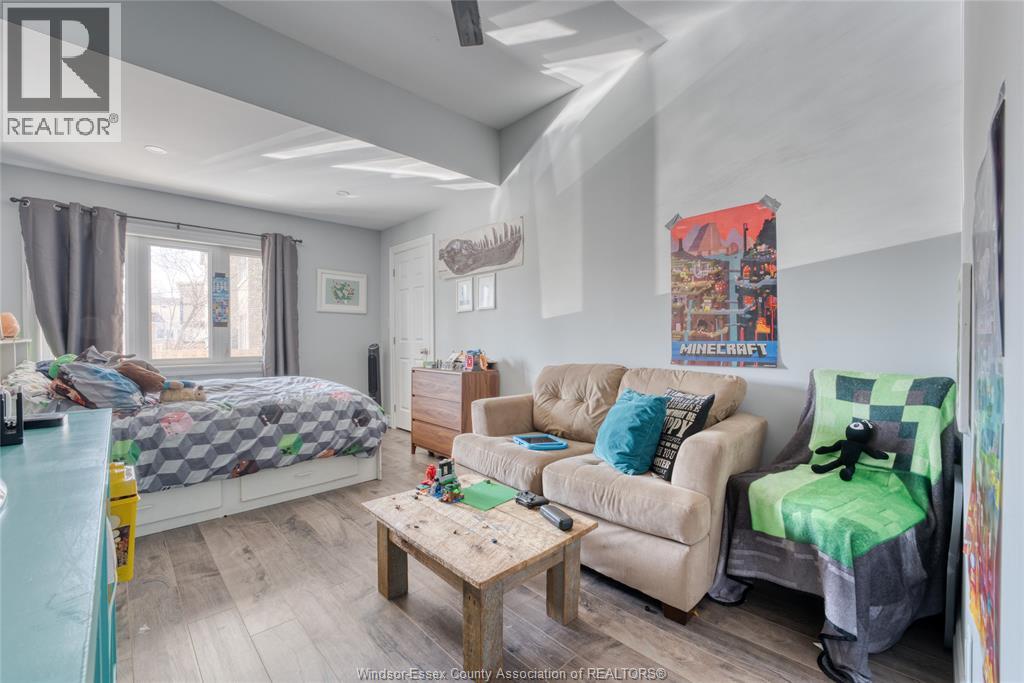 A bedroom with a bed, couch, and coffee table.