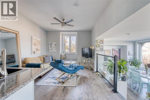 A living room with a blue chair and a television.