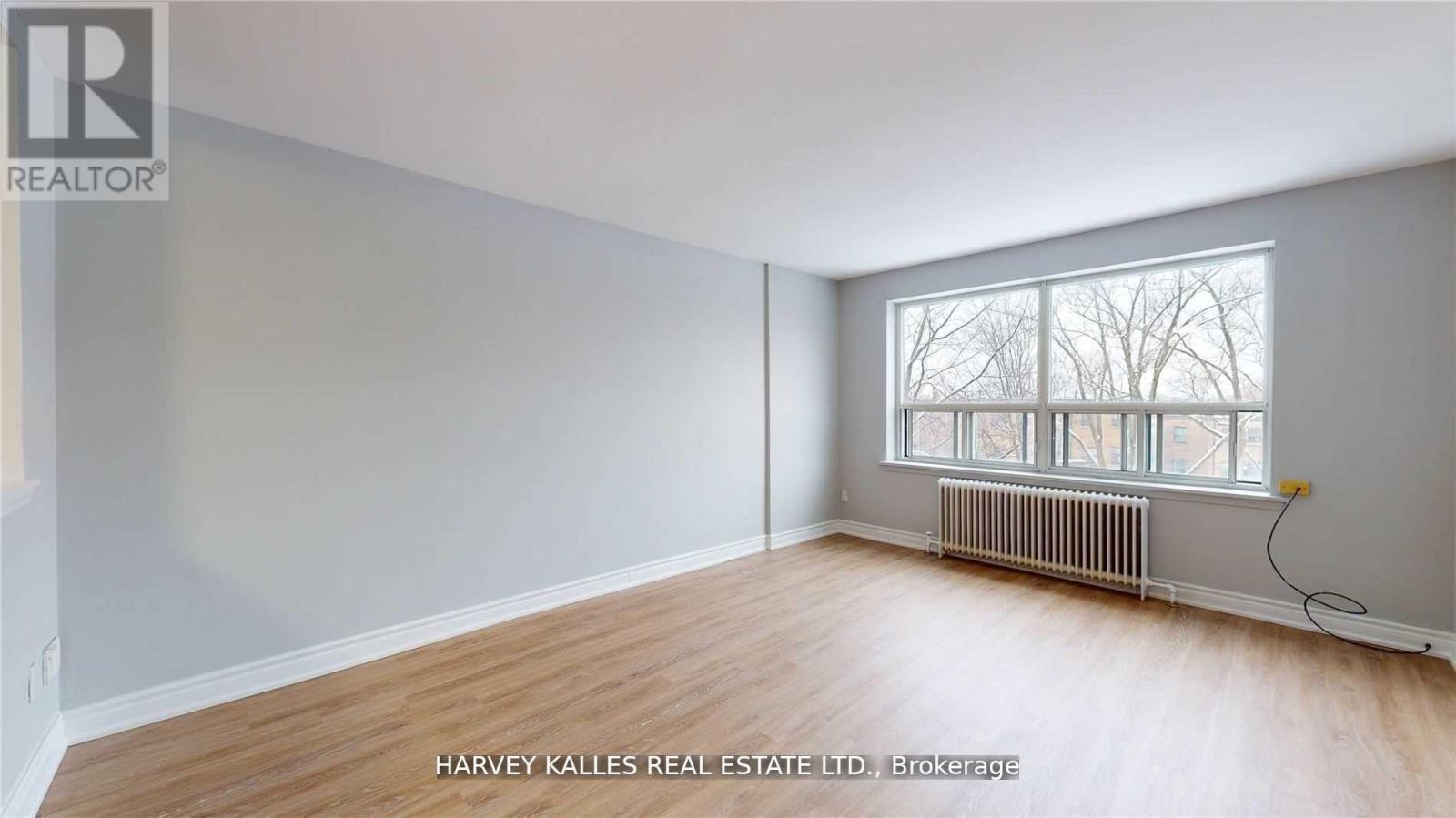 A room with a window and a radiator is for sale.