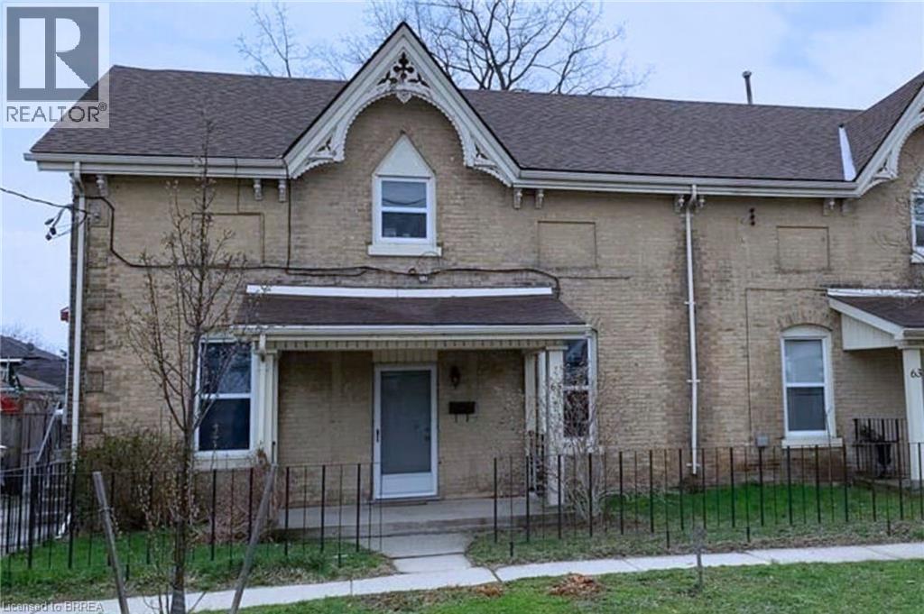 A house with a brown brick exterior and a white door.