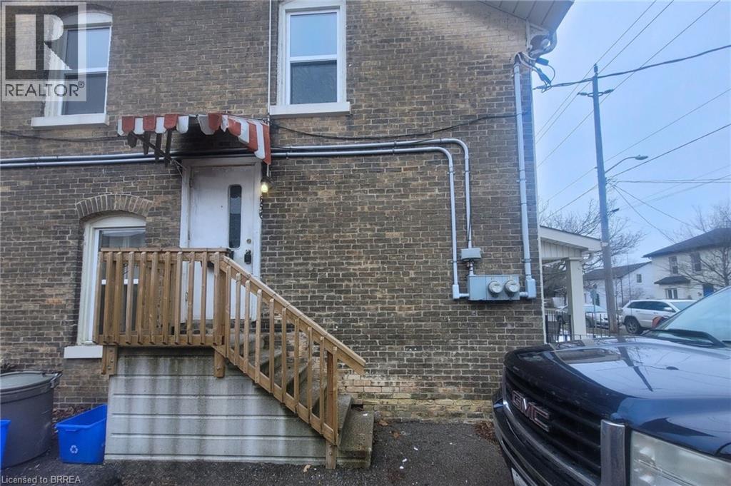 A house with a wooden staircase leading to a door.