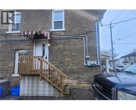 A house with a wooden staircase leading to a door.