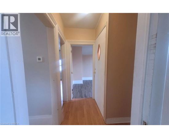 A hallway with a door at the end.
