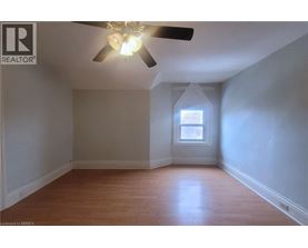 A room with a ceiling fan and a window.