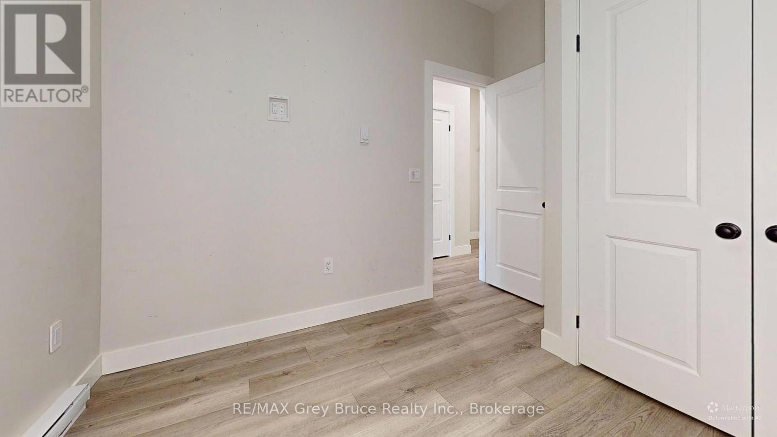 A room with a REALTOR® logo on the wall.