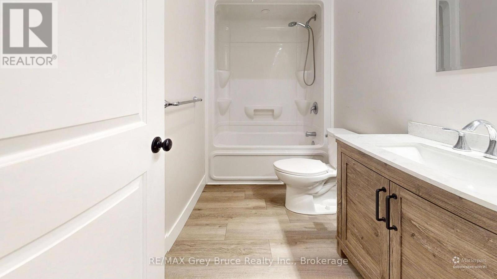 A bathroom with a toilet, sink, and bathtub.