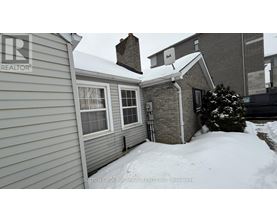 A house with a snow-covered ground and a chimney.