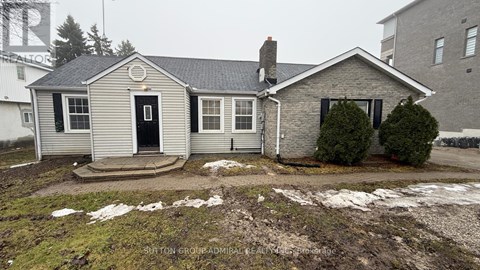 A house with a snow-covered ground and a chimney.