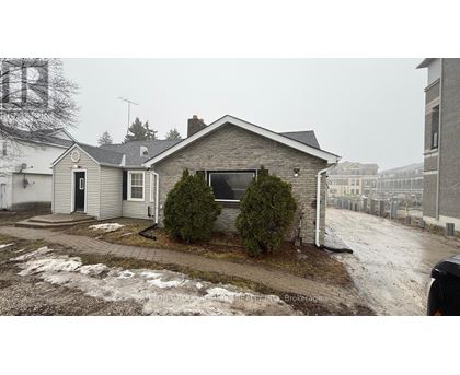 A house with a black door and a sign that says REALTOR.
