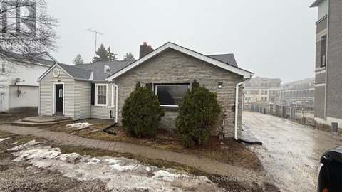 A house with a black door and a sign that says REALTOR.