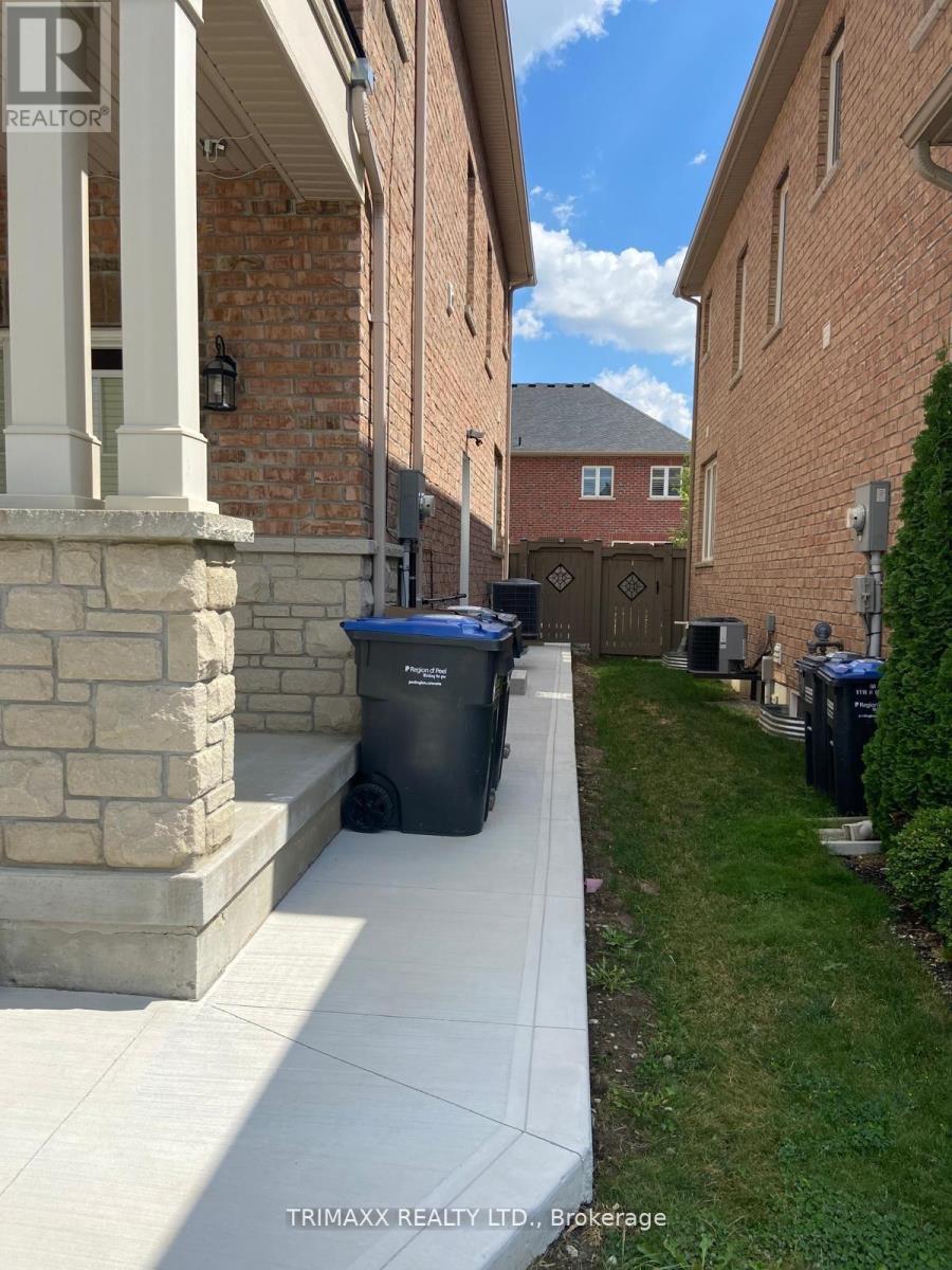 A residential area with a house and a trash bin.