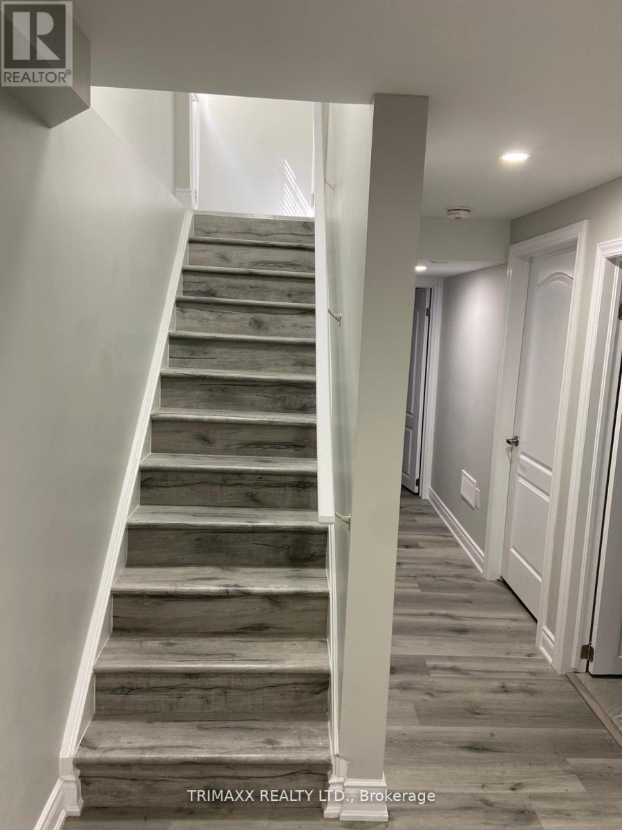 A staircase with wooden steps and white railings.