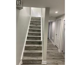 A staircase with wooden steps and white railings.