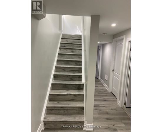 A staircase with wooden steps and white railings.