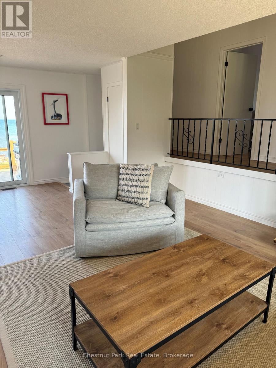 A living room with a grey couch and a wooden coffee table.