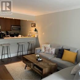A living room with a grey couch and a coffee table.